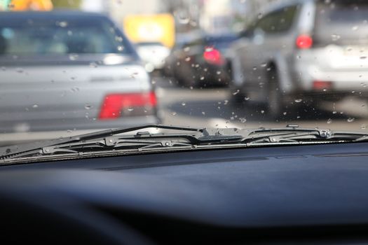 picture of car interior with rain drops on windshield