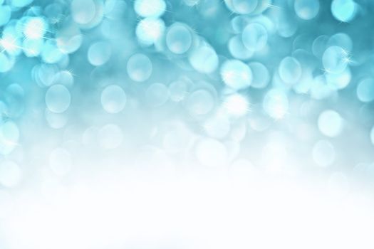 Abstract background of icy blue holiday lights with copy space.