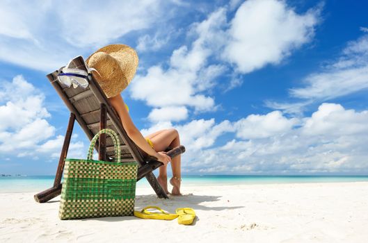 Girl on a tropical beach with hat