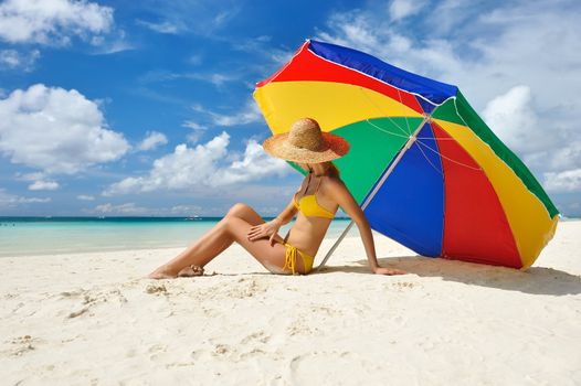 Girl on a tropical beach with hat