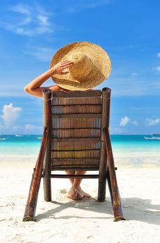 Girl on a tropical beach with hat