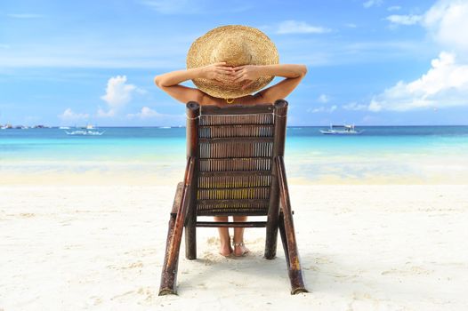 Girl on a tropical beach with hat