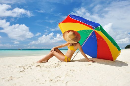 Girl on a tropical beach with hat