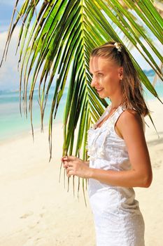 Woman on beautiful beach with palm trees at Philippines