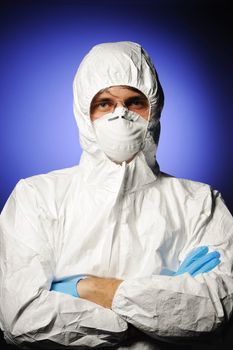 Scientist in protective wear, glasses and respirator 