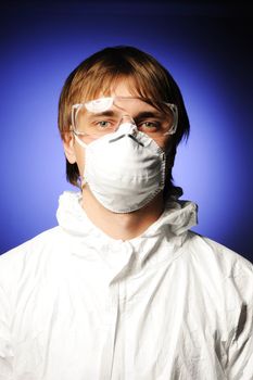 Scientist in protective wear, glasses and respirator 