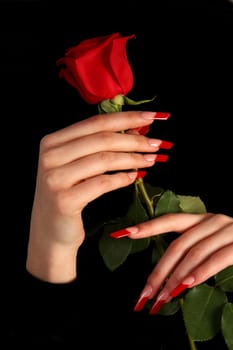 Human fingers with long fingernail and beautiful manicure isolated on black