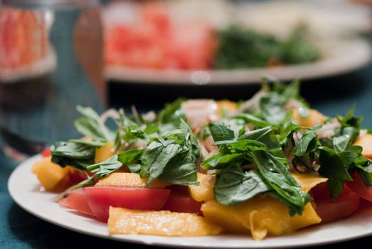 Green salad served with mango and tomatoes