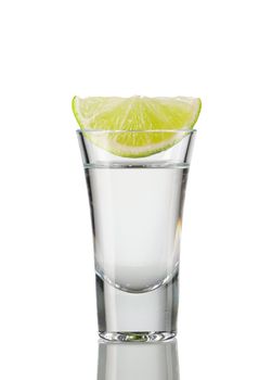 Tequila shot with lime isolated on white