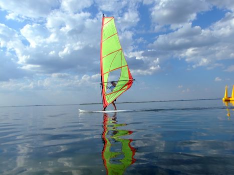 Windsurfer and its reflection in water of a gulf 2