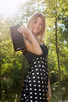 Portrait of a smiling young blonde in the forest