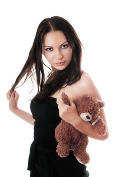 Young sexy brunette posing with teddy-bear toy. Isolated on white