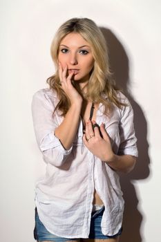 Beautiful blond young woman in a white shirt