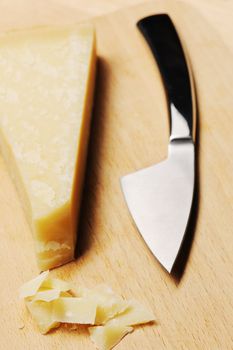 Parmesan cheese and knife on board