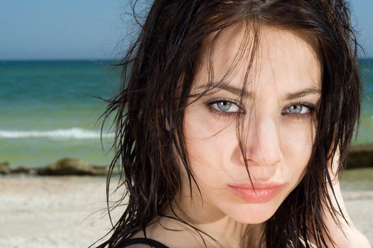 Portrait of the pretty young woman on a beach