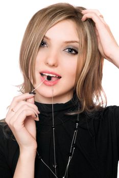 Portrait of beautiful girl with a bead in her mouth. Isolated