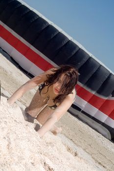 Sexy young  woman against a parachute of kite