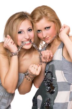 Two playful young women bound a chain to each other