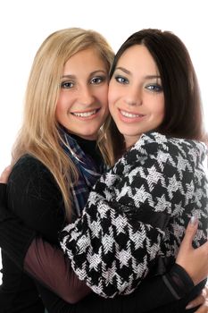 Portrait of two attractive girls embracing. Isolated