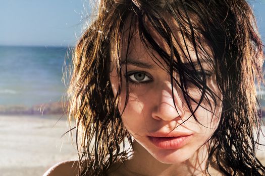 Portrait of the expressive young woman on a beach