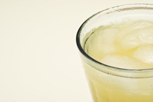 macro of a cocktail glass with ice isolated on white background