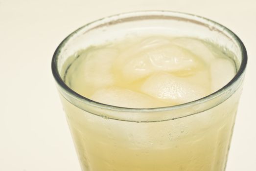 macro of a cocktail glass with ice isolated on white background