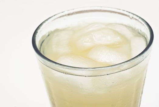 macro of a cocktail glass with ice isolated on white background