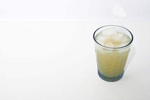 elegant cocktail glass with ice cube  isolated on white background