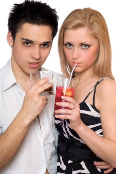 Attractive young couple with cocktails. Isolated on white