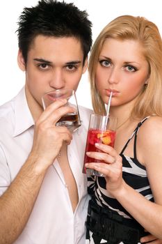 Pretty young couple with cocktails. Isolated on white