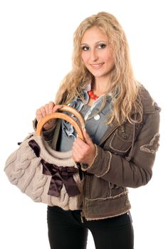 Portrait of smiling young blonde with a handbag. Isolated