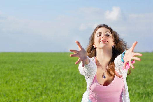 Portrait of playful young woman in a green field