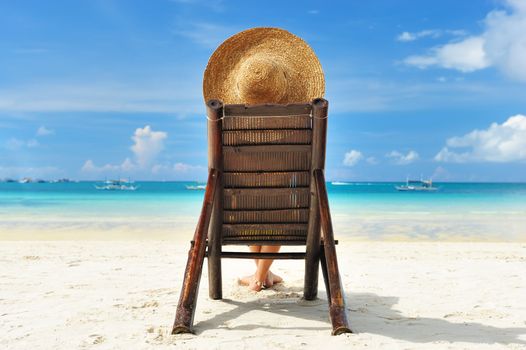 Girl on a tropical beach with hat