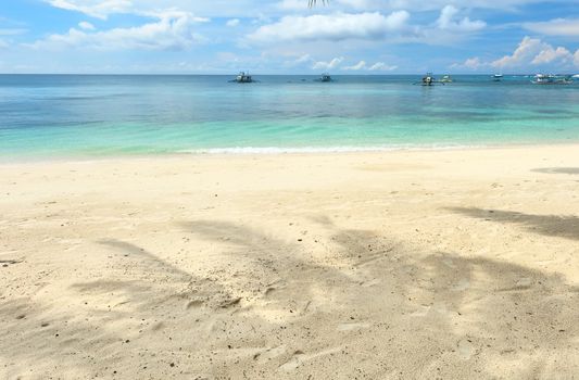 Beautiful beach with palm trees shadow at Philippines