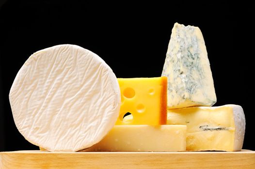 Various types of cheese over black 