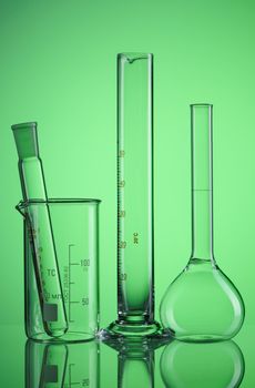 Chemical flasks over green background