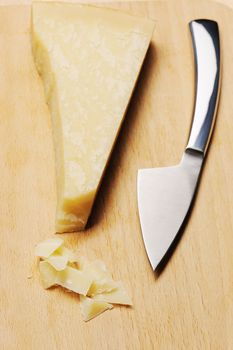 Parmesan cheese and knife on board