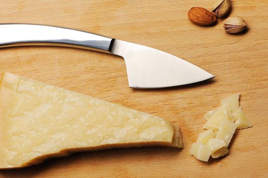 Parmesan cheese and knife on board
