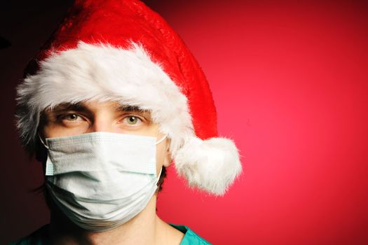 Surgeon with mask in Santa's hat