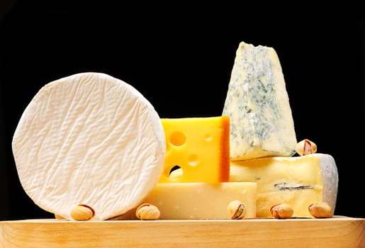 Various types of cheese over black 