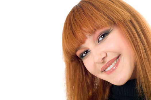 Portrait of the attractive smiling redheaded woman. Isolated