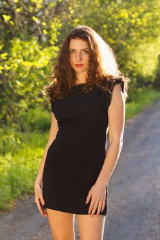 Portrait of a cute young woman in black dress