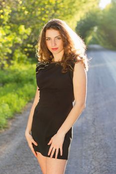 Portrait of a beautiful young woman in black dress