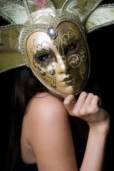 Portrait of young woman in a Venetian mask