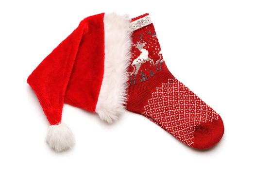 Christmas stocking and Santa hat isolated on white
