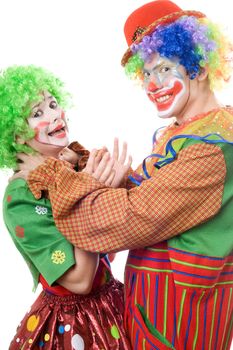 Clown tries to strangle a female clown. Funny picture