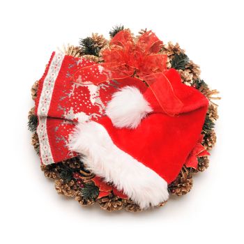 Traditional christmas wreath with santa hat an stocking isolated on white
