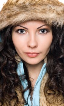Closeup portrait of beautiful young brunette in the hood