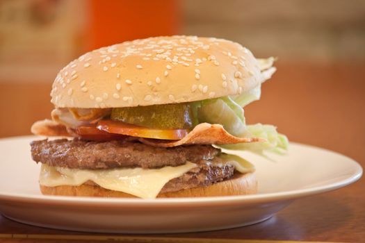 Double cheeese burger in white plate at a shop, shallow depth of field