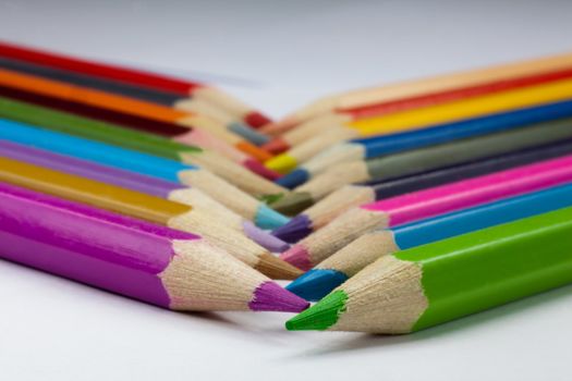 Colorful pencils being crossed.